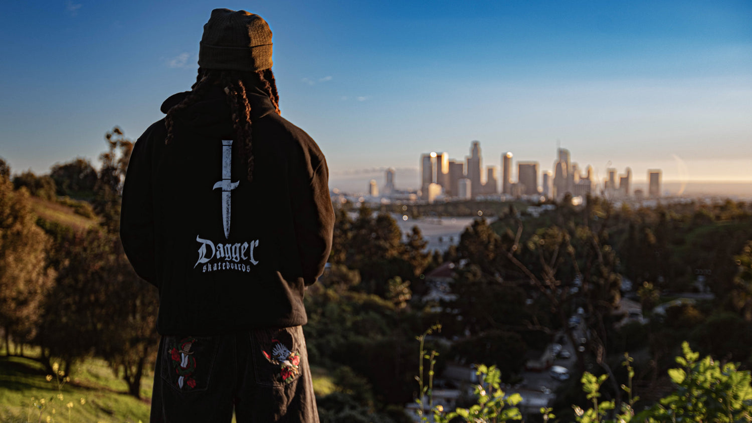 Skater chilling in los angeles wearing Dagger hoodie— lifestyle photo