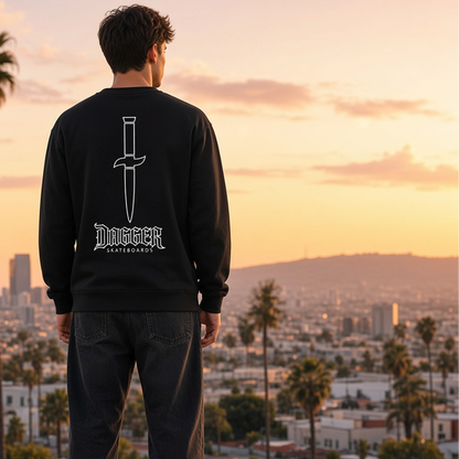 Model wearing black Dagger Outline Blade crewneck with white dagger back graphic at sunset