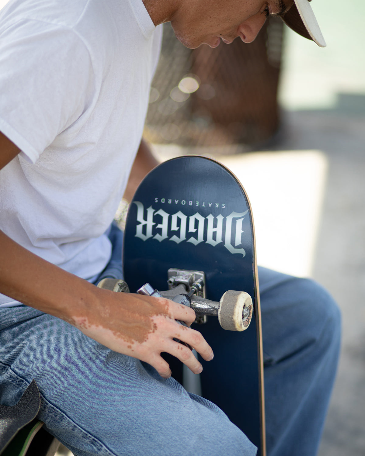 Carlos holding the Dagger Skateboards Midnight Blade deck during a skate session